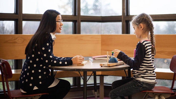 Therapist talking to a child.