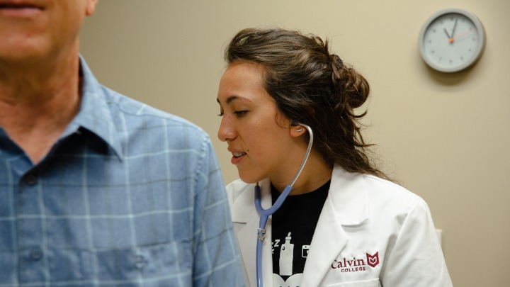 A nurse checking on a patient.