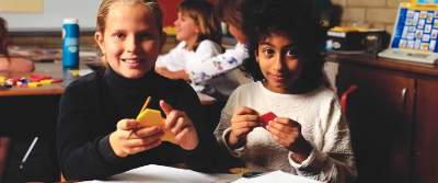 Transracially adopted children in a classroom together.