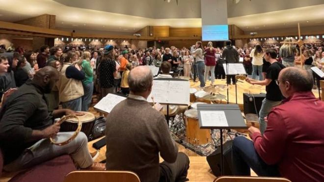 Three members of the board of trustees playing instruments during a worship service.