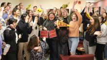 Stacia Hoeksema surrounded by students, faculty, staff, and family celebrating her.