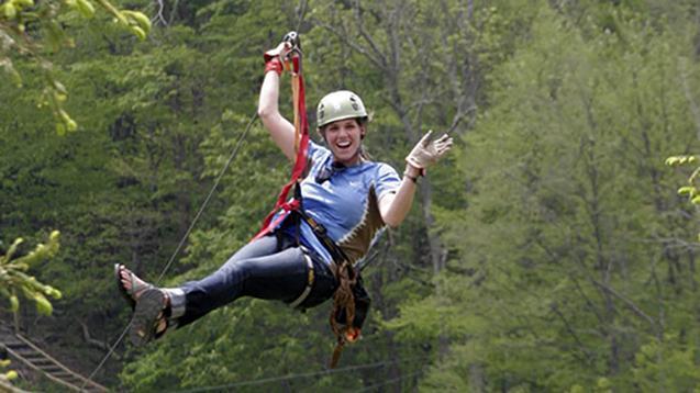 Calvin student hanging by zipline