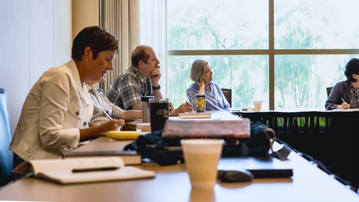 Faculty seated at a conference table