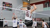 Man hitting volleyball at net