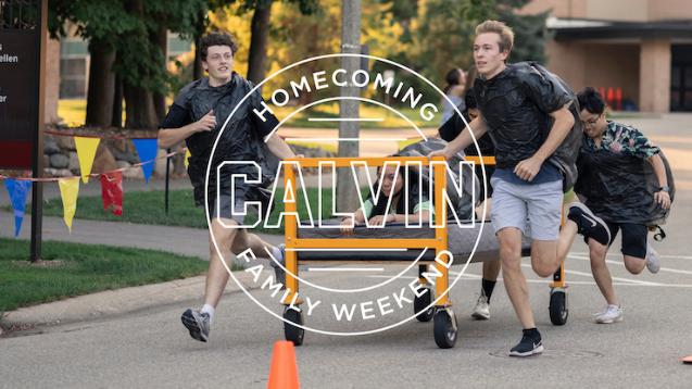 Students running down road pushing a bed