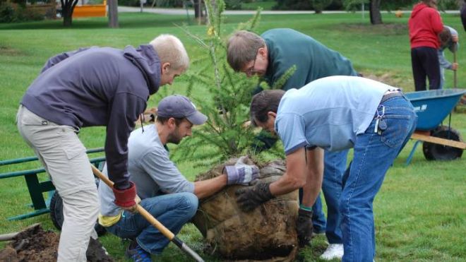 Volunteers with the Plaster Creek Stewards work on a project at Brookside Christian Reformed Church.