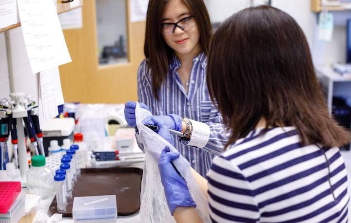 A student and teacher working in a chemistry lab