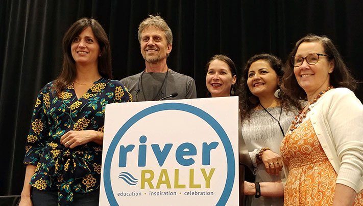 Five people pose for a photo after receiving an award.