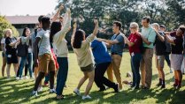 New Calvin University Students cheering and having a great time on the Commons Lawn