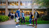 Students chatting in front of Pete's Coffee shop patio.