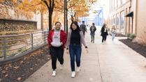 Calvin University students walking by blue bridge in Grand Rapids, Michigan