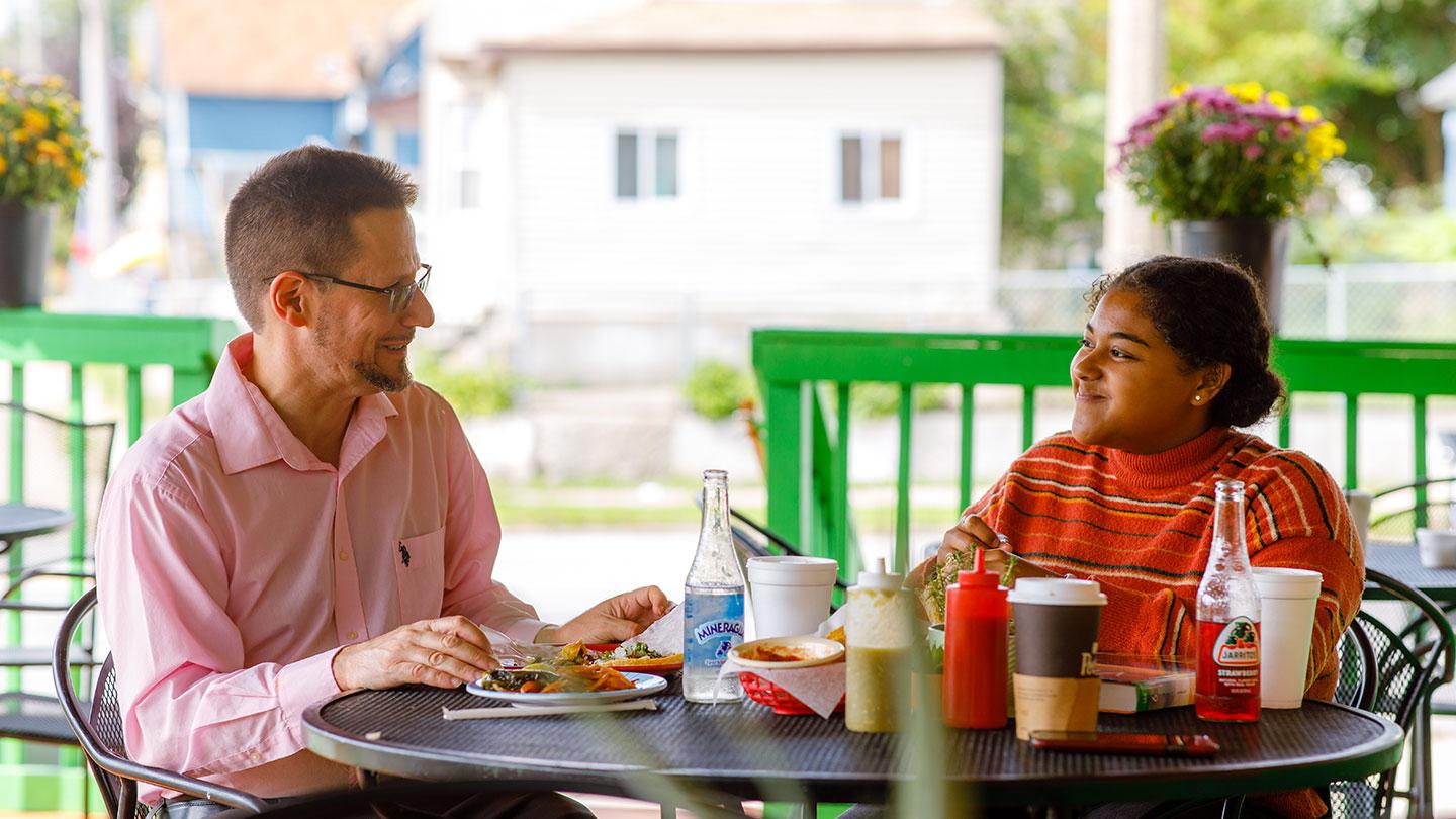 Professor and student at local taqueria, eating and conversing.