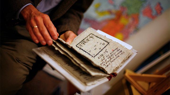 A person paging through a handmade book.