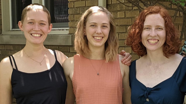 Three Calvin students standing side by side and smiling