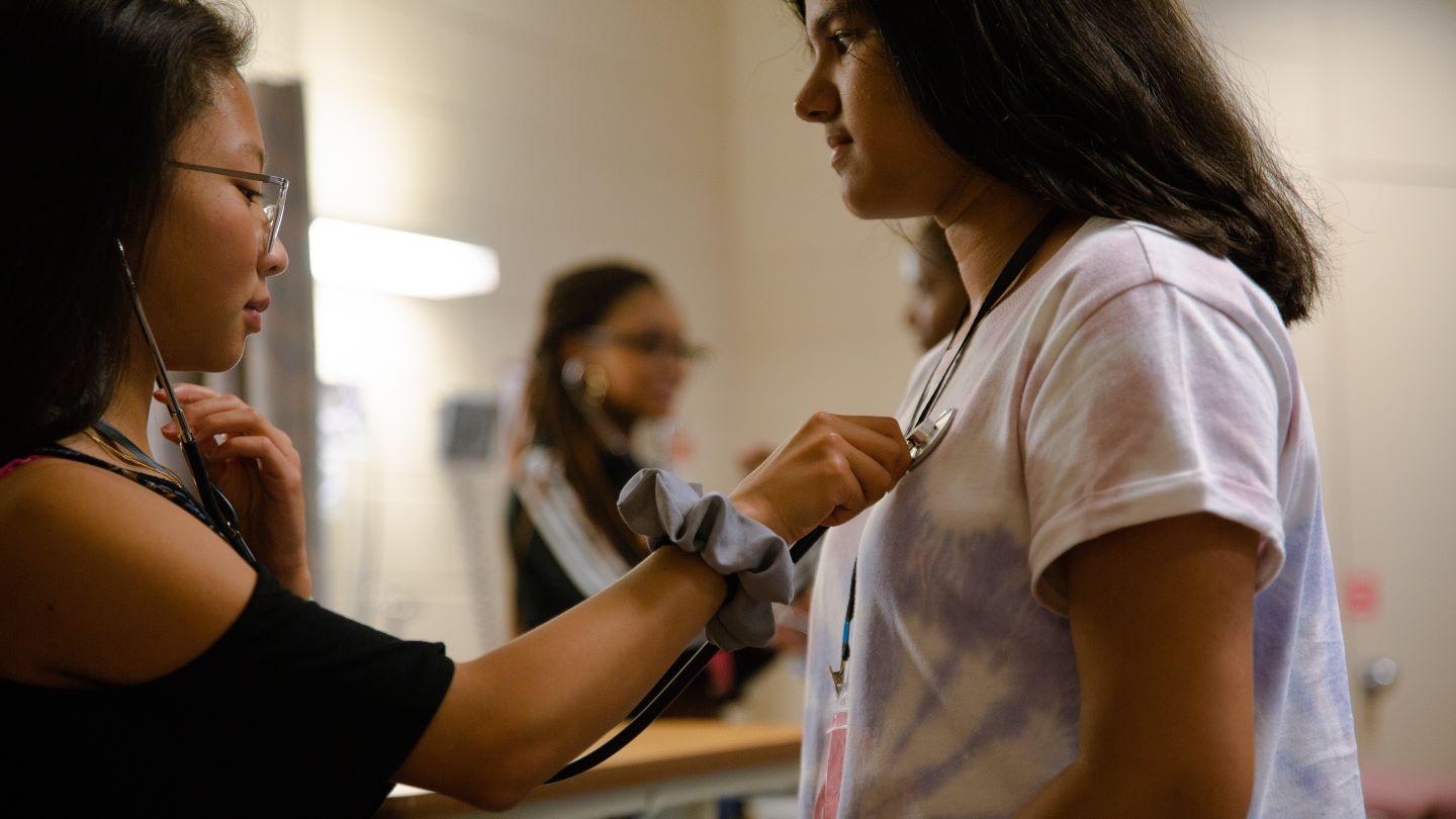 Nursing students practicing on dummy