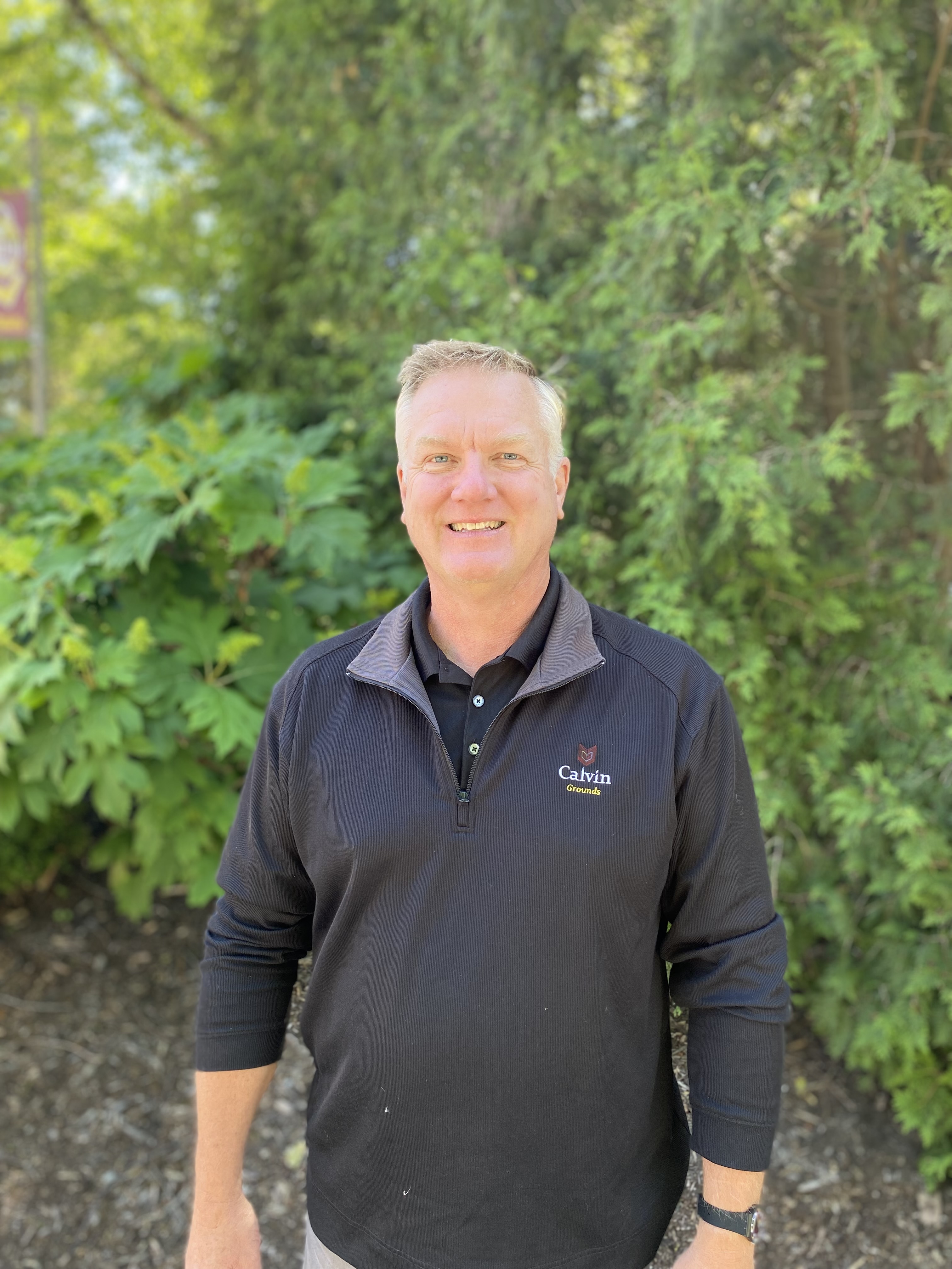 An adult male in a Calvin University jacket.